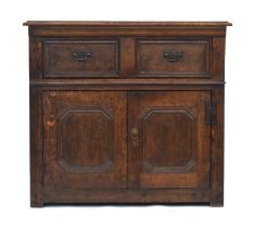 An 18th century and later oak cabinet, having a moulded top over single drawer and cupboard doors