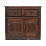 An 18th century and later oak cabinet, having a moulded top over single drawer and cupboard doors