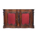 A Victorian marble topped rosewood serpentine sideboard, the silk panelled doors with applied carved