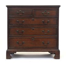 An 18th century oak chest, the moulded top above two short and three graduating drawers, on