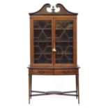 A Sheraton revival mahogany, satinwood and parcel painted glazed display cabinet, broken pediment