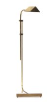 An adjustable brass reading lamp, on a cantilevered base