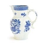 An 18th century Worcester blue and white cabbage leaf moulded jug, with mask spout, printed with the