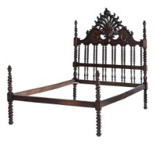 A carved hardwood double bed in 19th century Angli-Indial style, modern, the carved headboard on