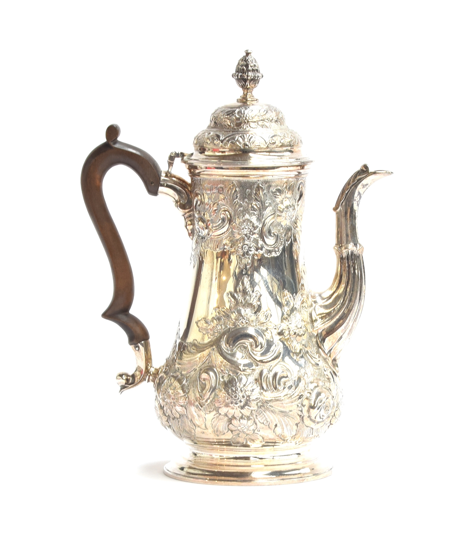 A late Victorian silver coffee pot by F B Thomas & Co, London 1897, heavily chased with foliage