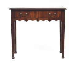 A George III mahogany side table, oval inlaid top, single frieze drawer and shaped apron, on