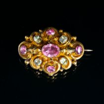 A mid Victorian gold brooch, set with chrysoberyl and foiled topaz stones, unmarked but tests as