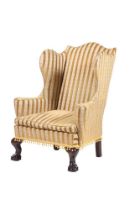 A mahogany and upholstered wingback armchair in George III style, 19th century, 117cm high