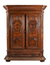 A massive 18th century Continental walnut armoire, the two doors heavily moulded with hearts and