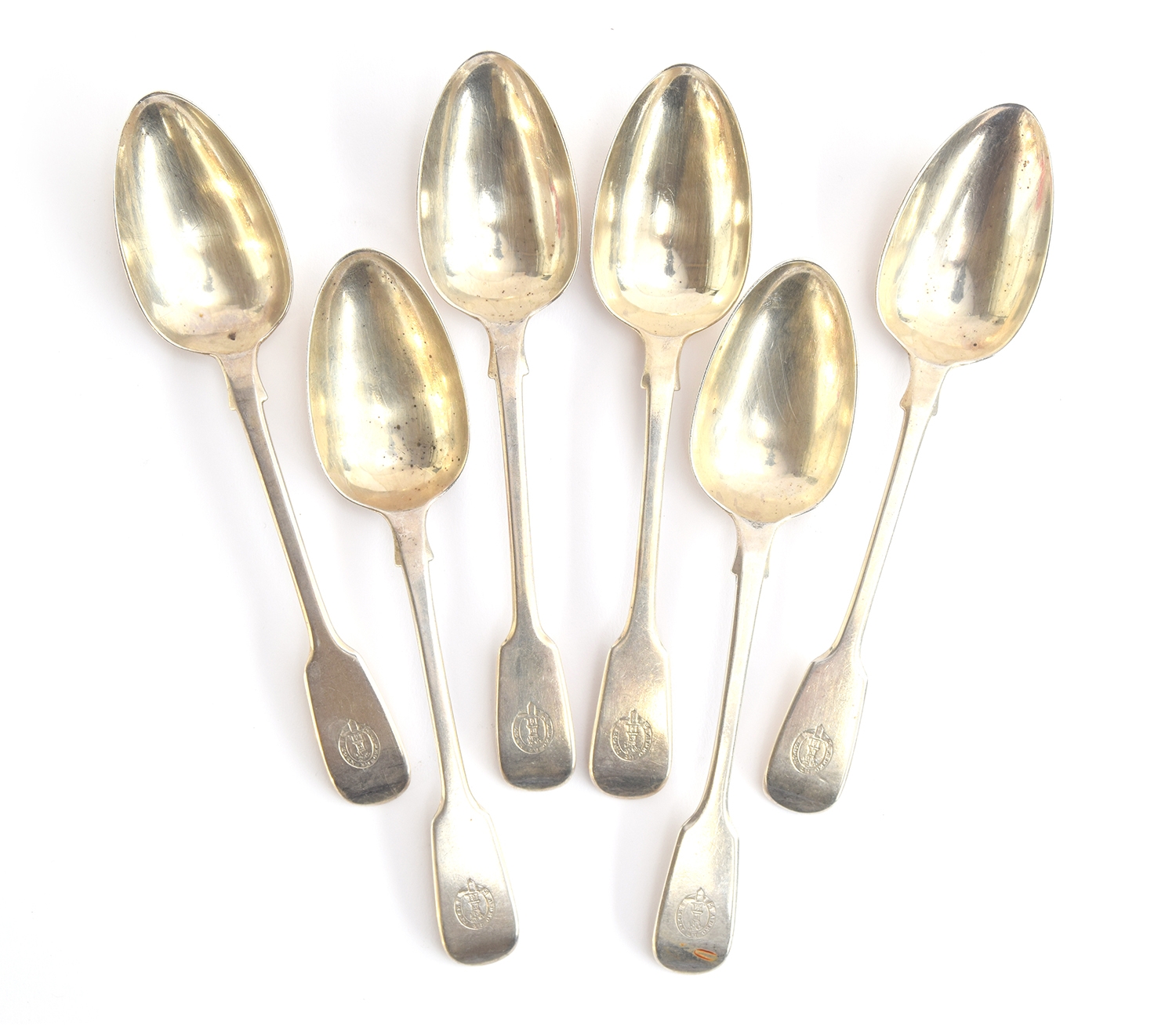 A set of six crested fiddle pattern dessert spoons by William Theobalds & Robert Metcalfe