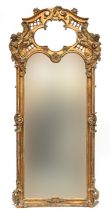 A very large rococo style gilt gesso mirror, the scrolling lattice cresting with quatrefoil
