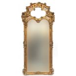 A very large rococo style gilt gesso mirror, the scrolling lattice cresting with quatrefoil