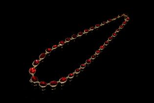 A Georgian gold mounted garnet riviere necklace, the 34 foil backed garnets in closed back