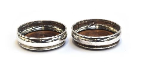 A pair of silver wine coasters by John Henry Odell, London 1972, 14cm diameter