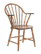 A 19th century ash and elm continuous arm Windsor chair, probably Yealmpton c.1815, the compound