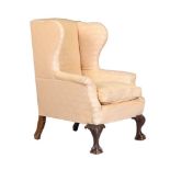 A mahogany and upholstered wingback armchair in George III style, 19th century, 111cm high