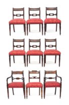 A set of six William IV mahogany dining chairs, the ebony inlaid top rail on reeded scroll supports,