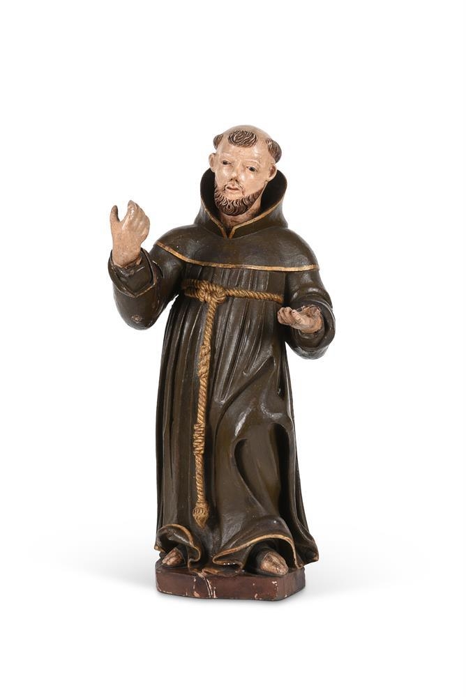 A 19th century carved and polychrome painted model of a monk, possibly St. Francis of Assisi, with