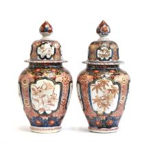 A pair of 19th century Imari vases and covers, 40cm high
