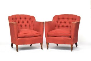 A pair of early 20th century deep button upholstered country house armchairs, each with feather