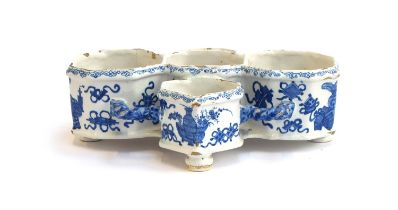 An 18th century Delft cruet stand, painted in a Chinese style with precious objects, marked AK to