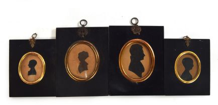 Four 19th century silhouette miniature portraits in ebonised frames, the largest 7x5.8cm