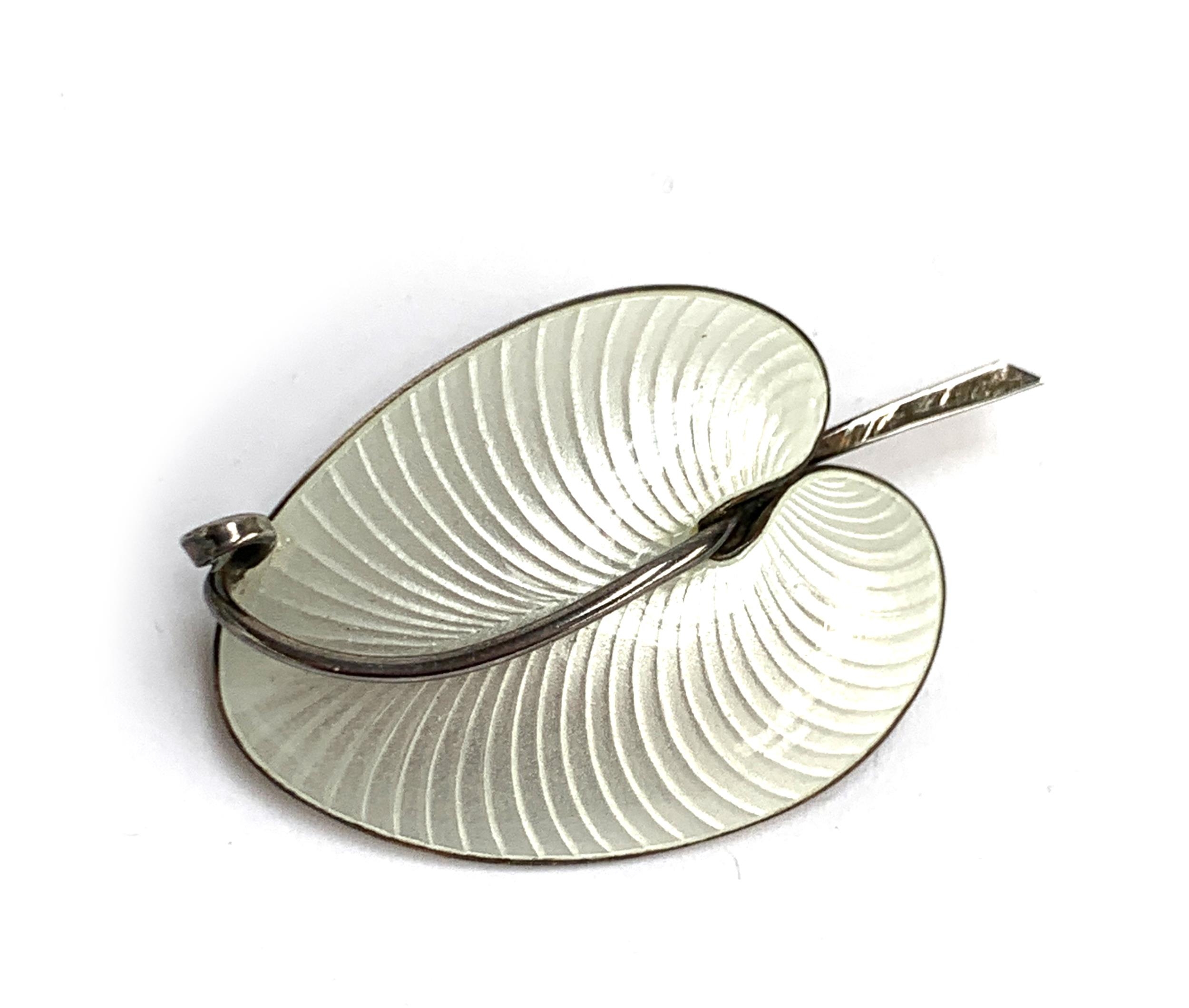 A Danish Volmer Bahner silver and white guilloche enamel brooch in the form of a stylised leaf,