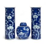 Two Chinese blue and white sleeve vases with prunus design, 30cmH; together with a similar ginger