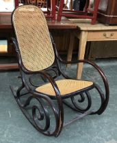 A bentwood Thonet style caned rocking chair