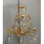 A gilt metal and glass drop 15 fitting chandelier, in need of restoration