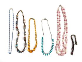 A collection of early 20th century beaded necklaces to include citrine glass, bezel set blue