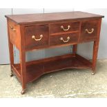 A 20th century mahogany buffet, four drawers with brass handles above a shaped undershelf, on