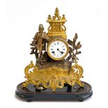 An early 20th century French gilt metal figural mantel clock, enamel dial with Roman numerals,