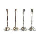 A set of four silver plated candlesticks with knopped stems and spreading circular feet, 41cmH