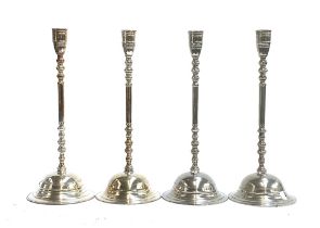 A set of four silver plated candlesticks with knopped stems and spreading circular feet, 41cmH