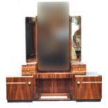 A French Art Deco maccasar ebony dressing table, triple plate mirrors, three plain frieze drawers,