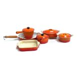 Le Crueset: two lidded casserole dishes, 27cmW and 22cmW, two saucepans, a square ceramic oven dish,