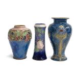 Three Royal Doulton stoneware tubelined vases, the smallest 21.5cmH stamped 8721X and incised CA,
