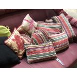 A quantity of striped and other scatter cushions