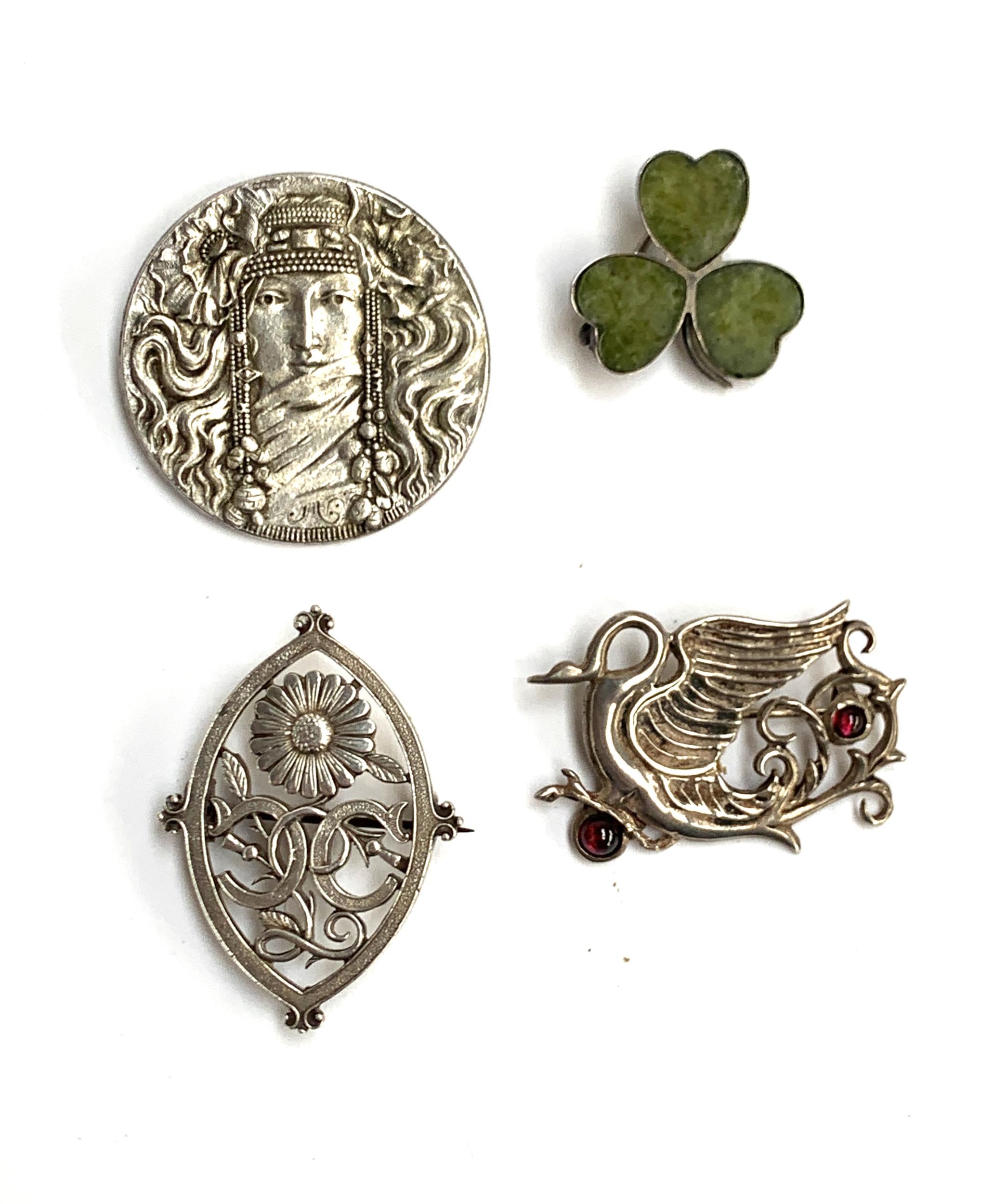 Four brooches: An early 20th century silver Connemara marble clover brooch, A silver Arts and Crafts