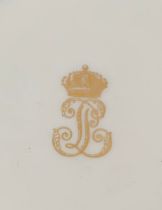 A framed 19th century Sevres porcelain plate (af), monogrammed with gilt LP cipher, part of the