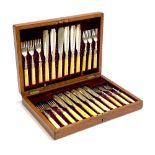 An oak canteen of silver plated bone handled fruit knives and forks for twelve place settings