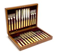 An oak canteen of silver plated bone handled fruit knives and forks for twelve place settings