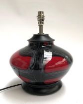 A glass table lamp of compressed form, red and black, 33cmH to top of fitting