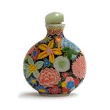 A late 19th/early 20th century Chinese glass snuff bottle, with polychrome enamel profuse floral
