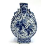 A Chinese blue and white porcelain moon flask, decorated with foo lions amongst ruyi clouds within