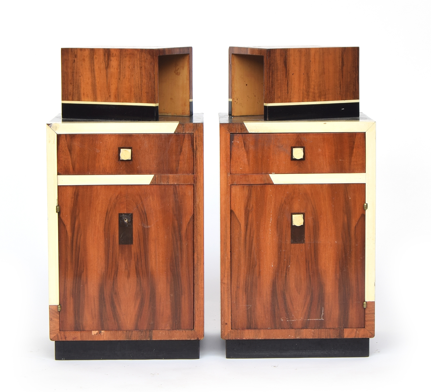 A pair of French Art Deco maccasar ebony square bedside cabinets, each with an offset box niche
