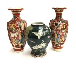 A pair of Japanese vases, 31.5cmH; together with one other depicting storks, with hole drilled for