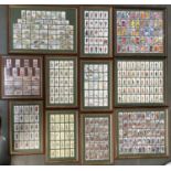 A quantity of framed and glazed cigarette cards to include Player's, Will's, and Carreras