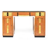 A French Art Deco pedestal desk, parcel gilt and ebonised, with carved foliate and scallop panels,